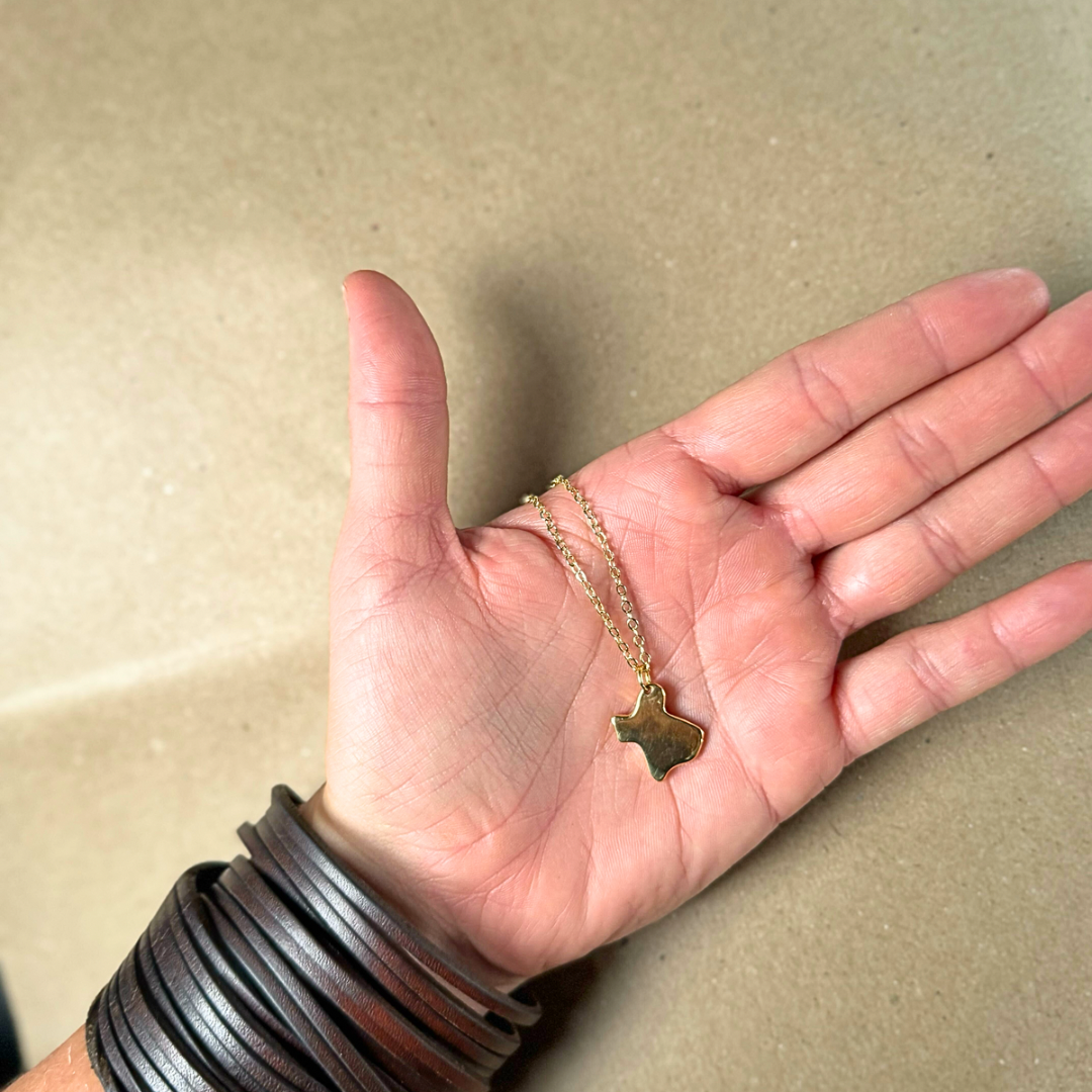 Gold Texas-shaped necklace supporting Texas flood recovery