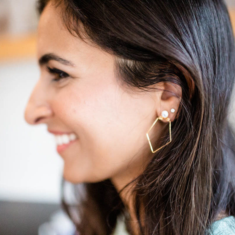 Ethically made earrings with 18k gold geometric shapes and white paper bead studs