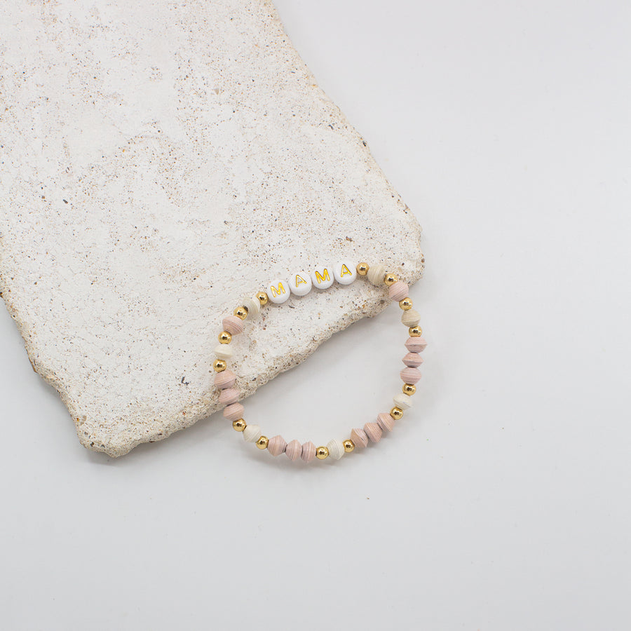 Ethically made stack of letter bead bracelets with word inspire