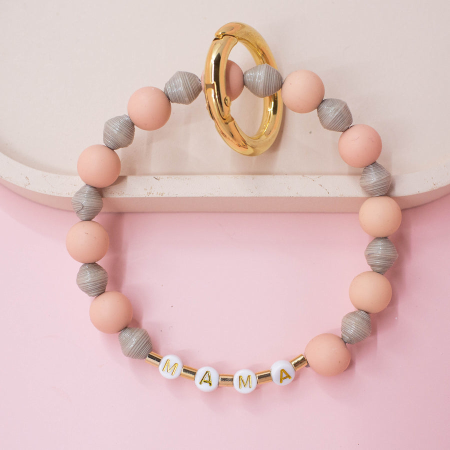 Ethically made key ring made with handmade paper beads and silicone beads with MAMA on it 