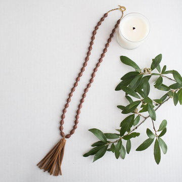 The Chai Necklace: brown handmade paper beads with fair trade certified leather tassel necklace by artisans in the Horn of Africa