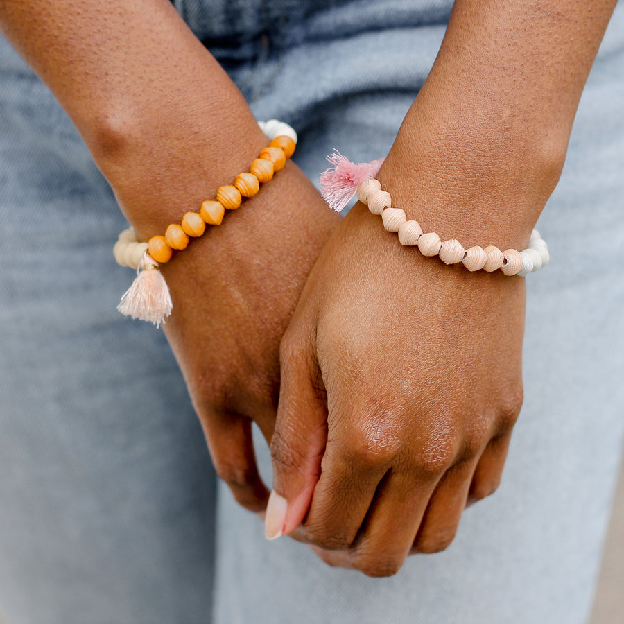 The Jetsetter Tassel Bracelet: yellow and orange handmade paper bead bracelet with tassel made by artisans in the Horn of Africa. Sustainable, Artisan-Made And Ethically Sourced