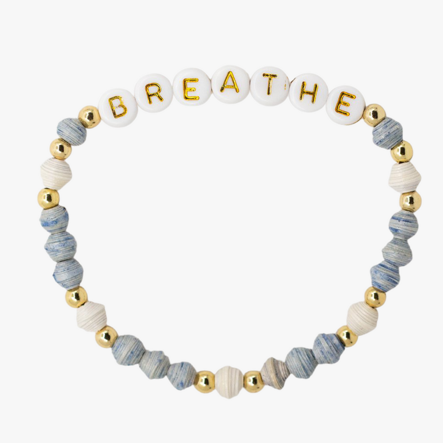 Ethically made stack of letter bead bracelets with word breathe