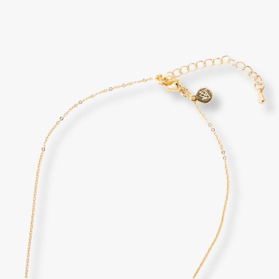 Ethically made 18k gold plated necklace with handmade paper bead and a bar pendant engraved with the phrase M is for Mama close up shot of back of necklace