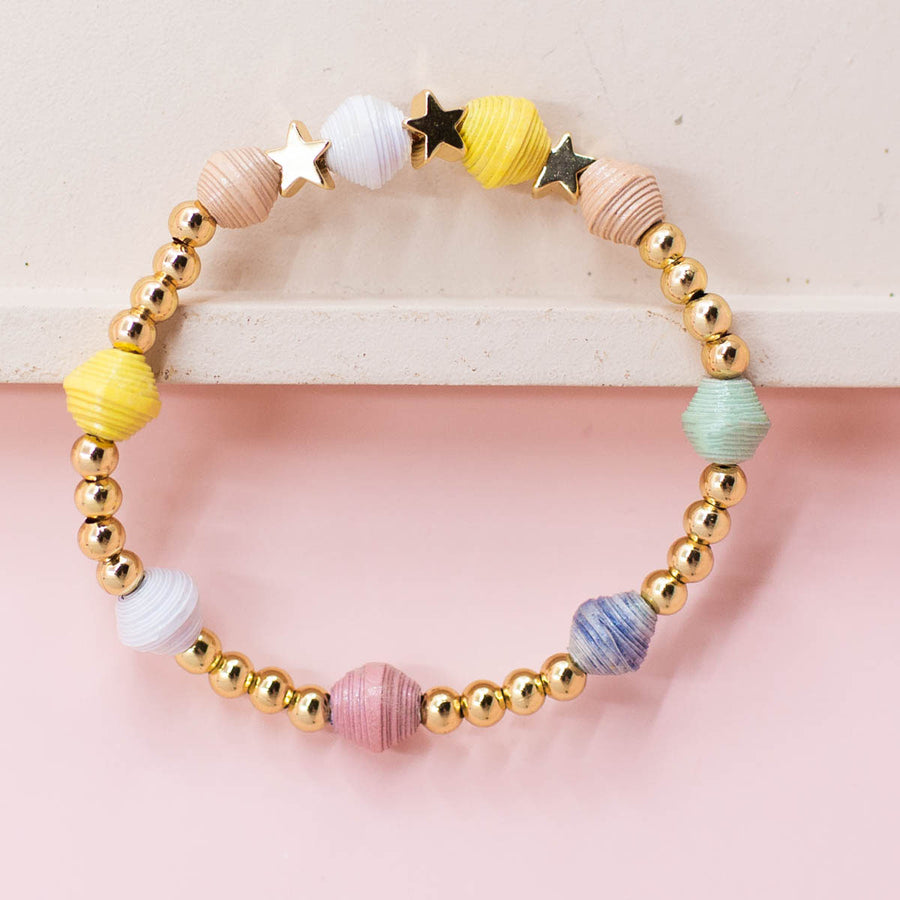 kid stretch bracelet ethically made with handmade paper beads, gold star beads and gold beads.